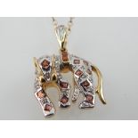 9ct yellow gold garnet and diamond accent panther pendant,