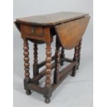 A 17th century and later oak drop leaf table,