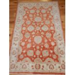 Zeigler style red ground rug, woven with flower heads,