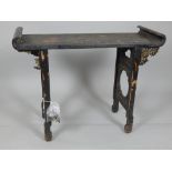 Early 19th century Chinese hardwood altar table, the rectangular top with scrolled ends,