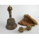 Sino-Tibetan brass bell decorated with foliage and Buddhist symbols, and a brass vajra,