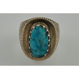 A gentleman's Persian turquoise dress ring set in a large silver band