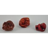 Three carved hardwood netsukes of a toad,