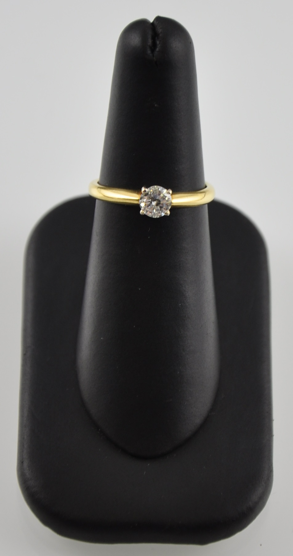 An 18 carat yellow gold solitaire diamond ring the claw set stone 0.