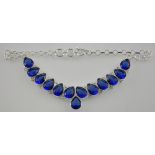 A silver collar necklace set with thirteen large blue pearshaped stone