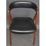 In the Danish style, a dining chair with upholstered black  leatherette back and seat, H.