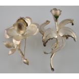A silver brooch modelled as a rose,