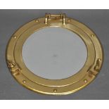 A circular mirror, modelled as a vintage-style brass porthole, Dia.