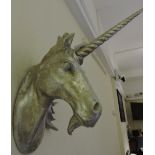 A silvered composition wall applique modelled as a unicorn's head