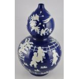 A large Chinese double gourd vase with a deep blue glaze and decorated with scenes of children