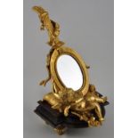 A Louis XVI design ormolu table mirror modelled as a cherub and lute on marble base, H.