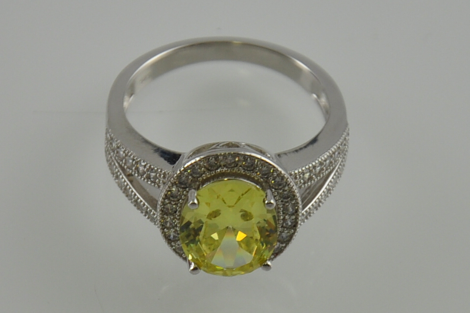 A silver cubic zirconia and yellow stone set dress ring