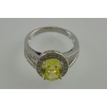 A silver cubic zirconia and yellow stone set dress ring