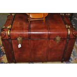 A leather and brass bound steamer trunk. H 60cm W 92cm D 90cm.