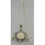 A silver filigree multicoloured stone and white carved centre pendant