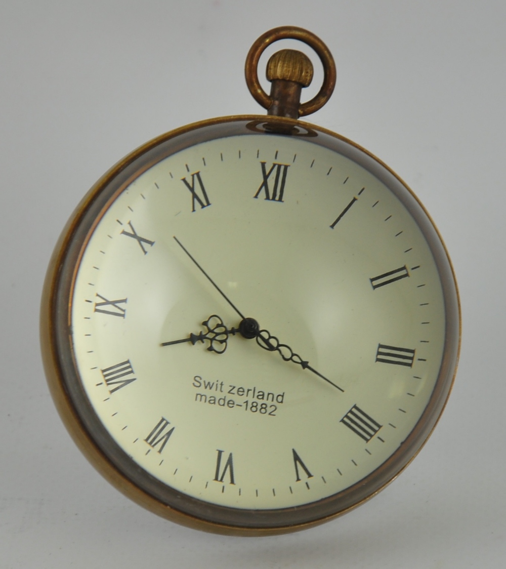 A large glass and brass reproduction desk ball clock
