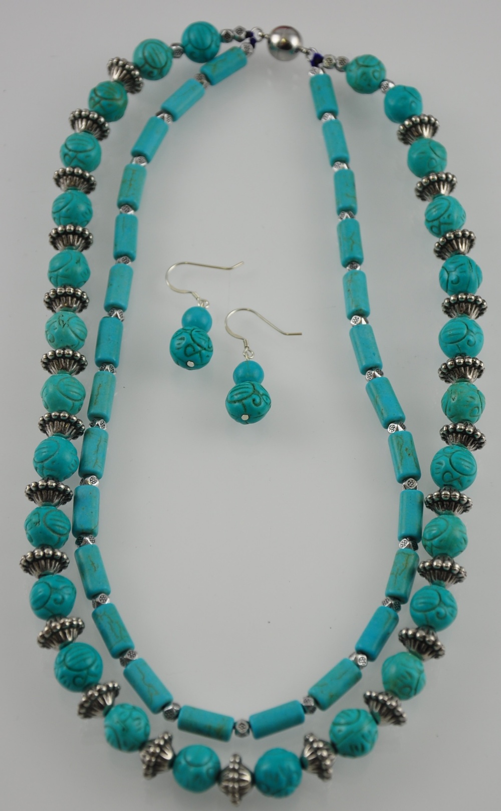 A turquoise coloured and white metal necklace and a matching earring set marked 925