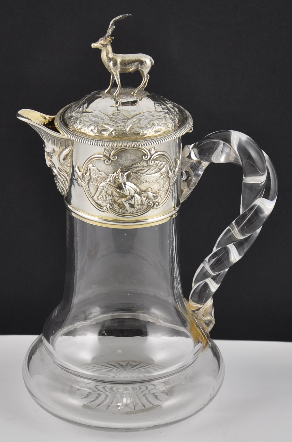 A Victorian silver mounted claret jug of Scottish interest with opposing Highland scenes depicting