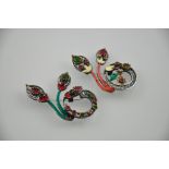 A pair of silver enamel brooches set with red and green stones