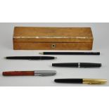 A Victorian abalone and satin birch pen box containing five vintage pens