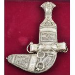 An Omani white metal ceremonial Khanjar with filigree handle and scabbard,