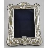 A silver Art Nouveau style easel back photograph frame