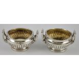 A pair of Georgian two handled silver salts, with fluted circular bodies, hallmarked London 1806,