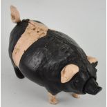 A novelty cold painted bronze pig desk bell