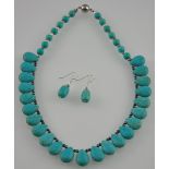 A turquoise coloured white metal necklace and  a matching earring set marked 925