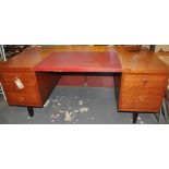 A large 1970's mahogany five drawer kneehole desk with red Rexine inset top,