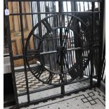 A large decorative mirror embellished with a metalwork clock face : 97 x 110cm