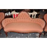 A Victorian walnut three piece salon suite recently reupholstered in patterned buttoned pale red