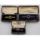 Three cased Edwardian 15ct gold bar brooches set amethyst, peridot,