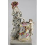 A Dresden style porcelain figure of a lady and cherub, emblematic of the Arts, H.