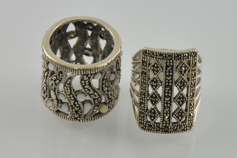 A silver dress ring, the pieced band set with marcasite,