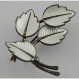 A Danish enamelled silver brooch modelled as an arrangement of four leaves