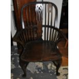 A Victorian style beech Windsor comb back armchair on cabriole legs