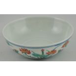 A Chinese Doucai bowl decorated with a scene of manadarin ducks on the water,