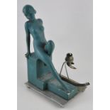 An Art Deco blue plaster and chrome table lamp modelled as a seated reclining nude,