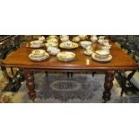 A mahogany eight seater dining table on turned legs,