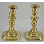 A pair of George II brass ejector candlesticks c.