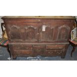 A Late 18th/ Early 19th Century oak mule chest enclosed by two arched panel doors over an