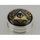 A white metal and Masonic-themed circular pill box, stamped 'sterling'.