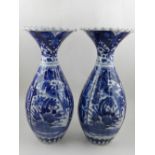 A pair of Japanese blue and white porcelain baluster vases, decorated with panels of birds and