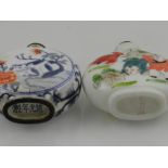 A Chinese blue and white porcelain snuff bottle decorated with cats, together with a similar snuff