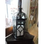 A pair of vintage style verdigris metal glazed lanterns
