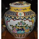 A Chinese earthen ware lidded jar and cover decorated with panels and peony