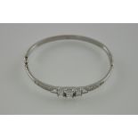 A silver bangle set with cubic zirconia stones