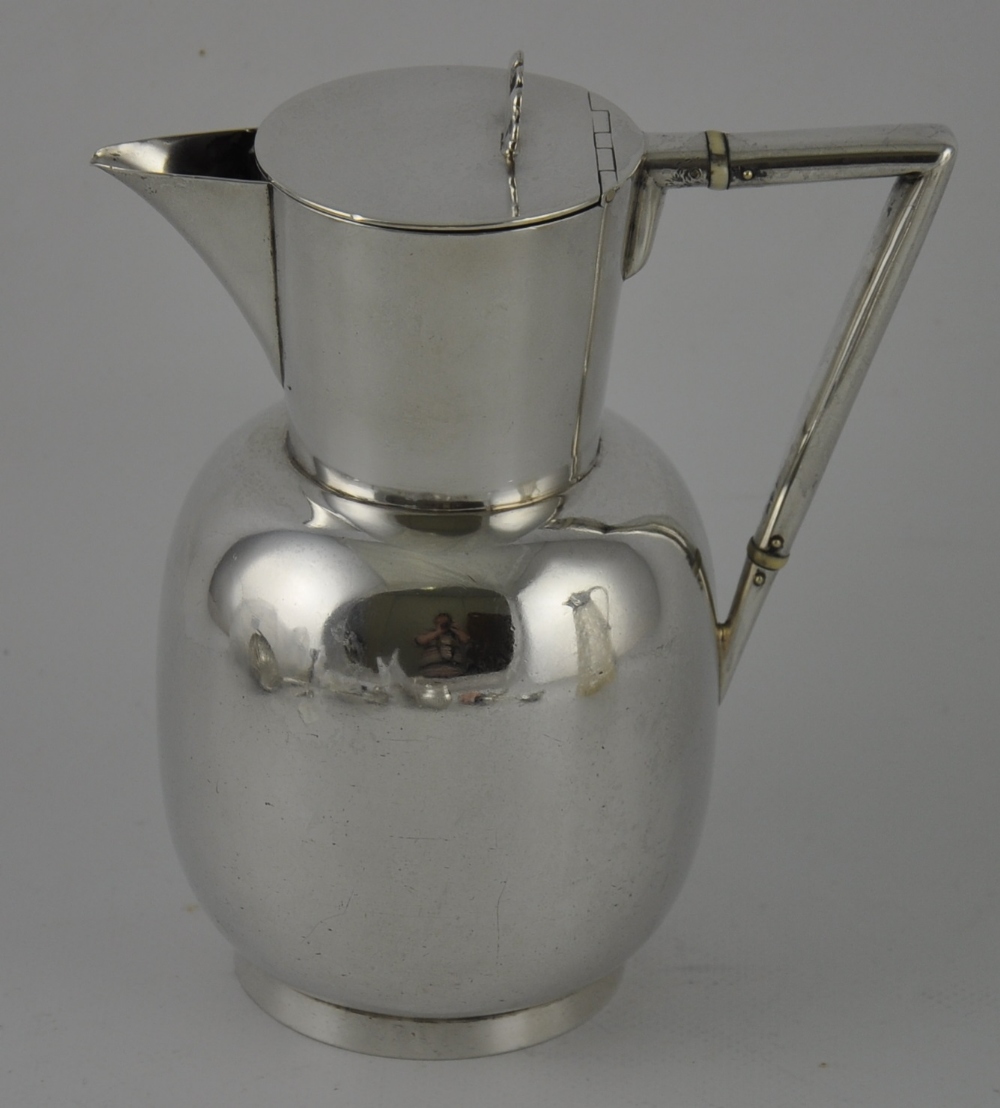 A Christopher Dresser design Victorian silver claret jug with angular handle,
