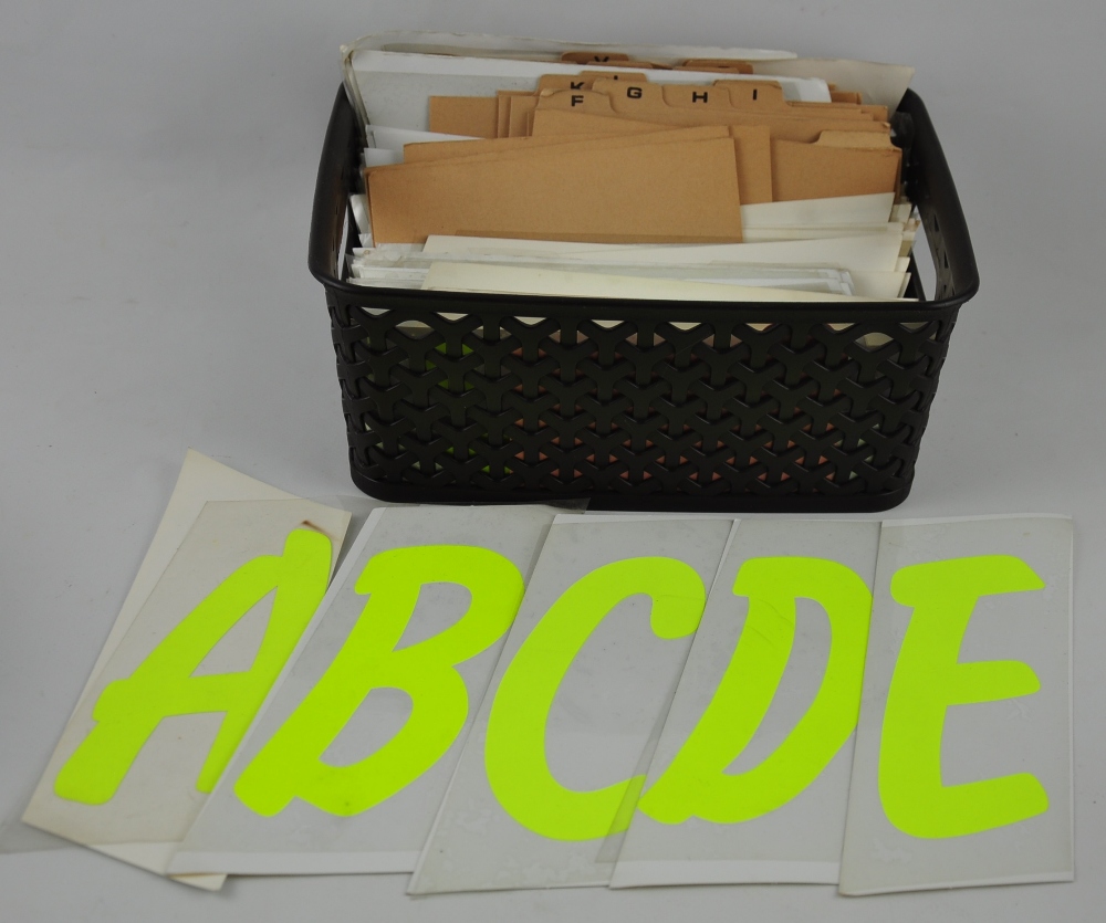 A box with index containing many large yellow letters